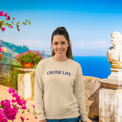 Woman wearing a 'CRUISE LIFE' sweatshirt with a scenic background of flowers and mountains.